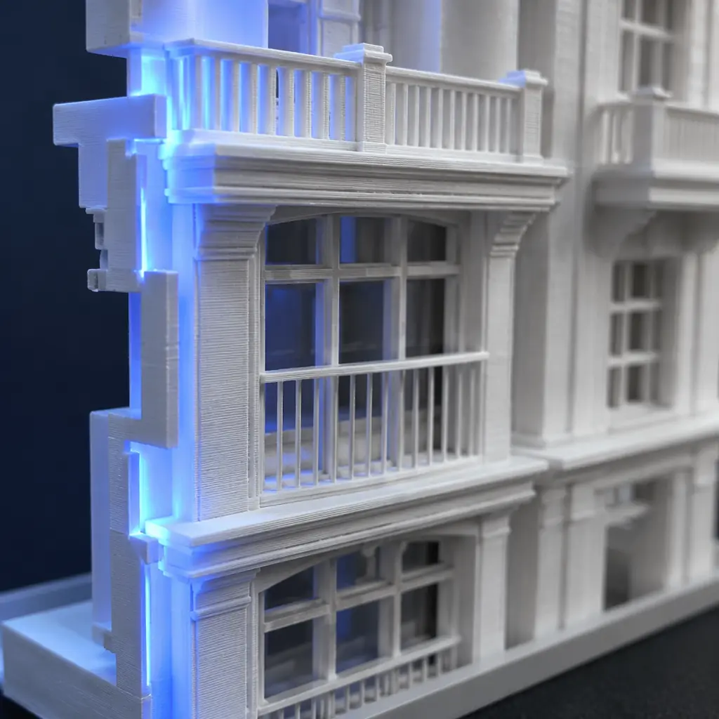 Photorealistic 3D printed white architectural scale model of a modern multi-story building on a dark presentation table, detailed facade elements visible, measuring scale figure nearby for reference, clean studio lighting